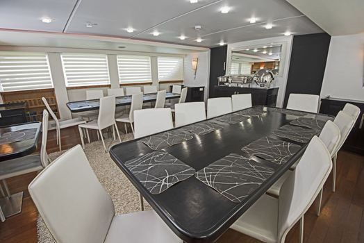 Interior design furnishing decor of the salon dining area in a large luxury motor yacht
