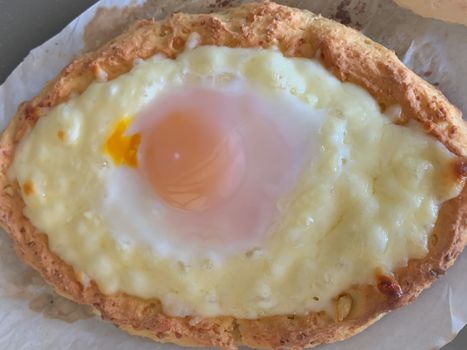 Home made diet proper nutrition khachapuri - traditional Georgian pie with cheese and egg. Horizontal stock image.