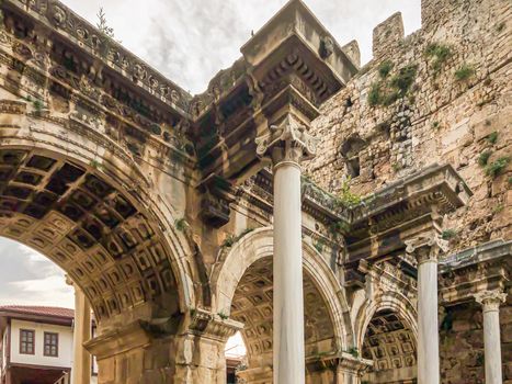 View of ancient monument Hadrian's Gate Uckapilar in old city of Antalya Kaleici, Turkey. Horizontal stock image.