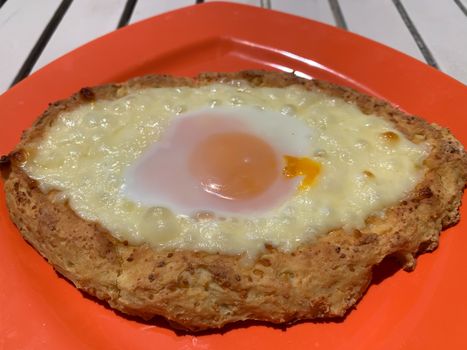 Home made diet proper nutrition khachapuri - traditional Georgian pie with cheese and egg. Horizontal stock image.
