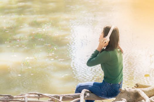 Young beautiful woman girl listening music headphones outdoor