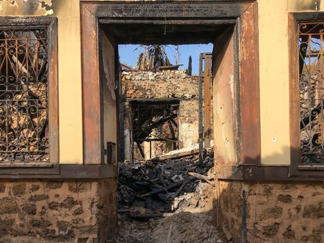 Ruins of burned ancient historical 2 floors house after fire disaster accident in old town of Antalya Kaleici Turkey. Stock image of heaps of ash and arson, collapsed roof and broken windows.