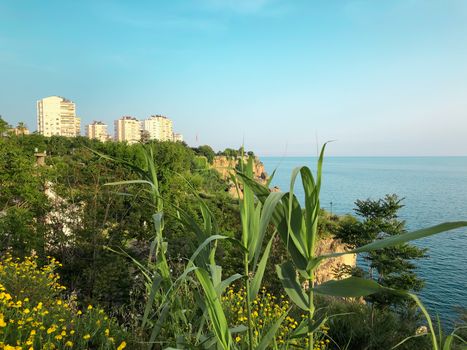 Beautiful buildings, green rocks and Mediterranean sea view in Antalya, Turkey. Horizontal stock image.