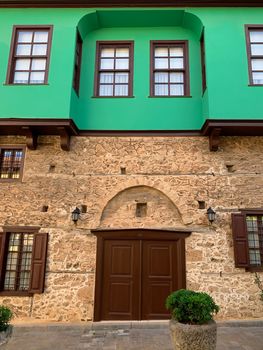 A facade of an old historical, building Ottoman time architecture in Antalya Old town Kaleici, Turkey. Vertical stock image.