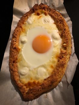 Home made diet proper nutrition khachapuri - traditional Georgian pie with cheese and egg. Horizontal stock image.