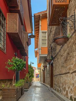 Narrow alley street with Ottoman style historical building in old town of Antalya Kaleici, Turkey. Vertical stock image. 