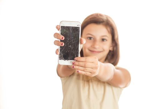 angry little girl holding an phone with broken screen in sudio