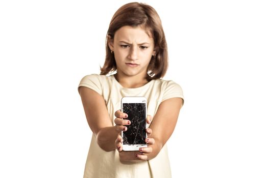 angry little girl holding an phone with broken screen in sudio