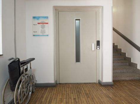 Entrance foyer in a medical centre with elevator and wheelchair