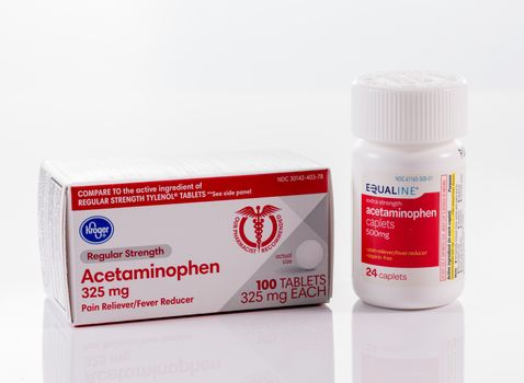 Morgantown, WV - 11 April 2020: Generic acetaminophen or paracetamol tablets for fever reduction in bottle on white background