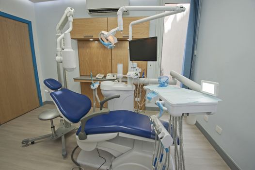 Interior design of dentist surgery room in medical clinic with chair and equipment