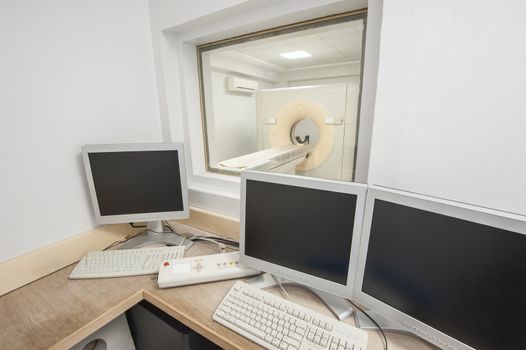 Hi-tech medical equipment CT scanner in hospital medical clinic center with control room