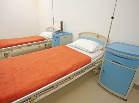 Two beds in a private hospital ward room