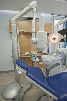 Interior design of dentist surgery room in medical clinic with chair and x-ray equipment