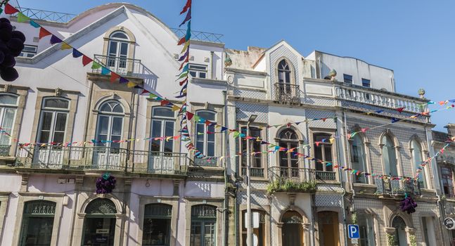 Ovar, Portugal - February 18, 2020: architectural detail of the typical houses of the city decorated for the carnival where people are walking on a winter day