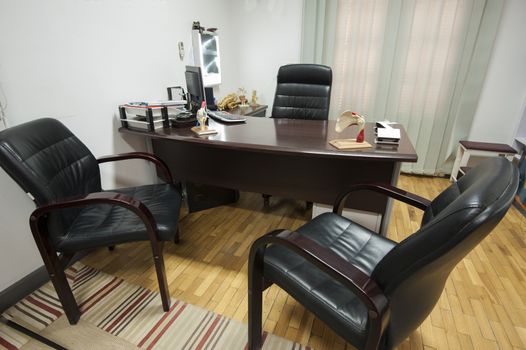 Consultation room in a doctors surgery with desk and chairs
