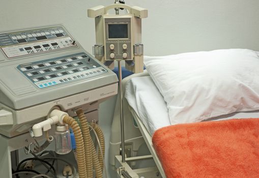 Ventilator machine next to a bed in the intensive care ward of medical center