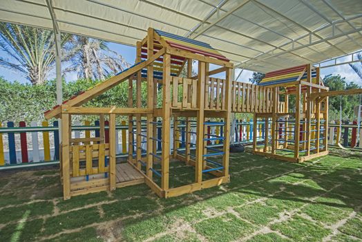 Large wooden climbing frame structure in children's playground area of luxury hotel