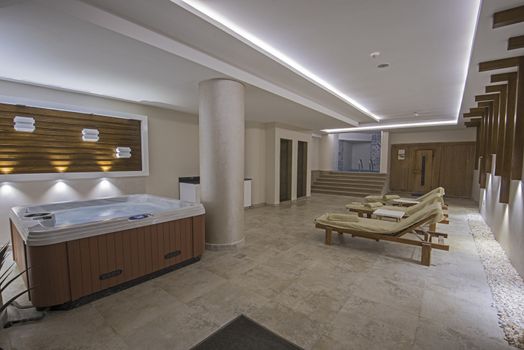 Beds and jacuzzi in a private VIP area of luxury health spa with sauna