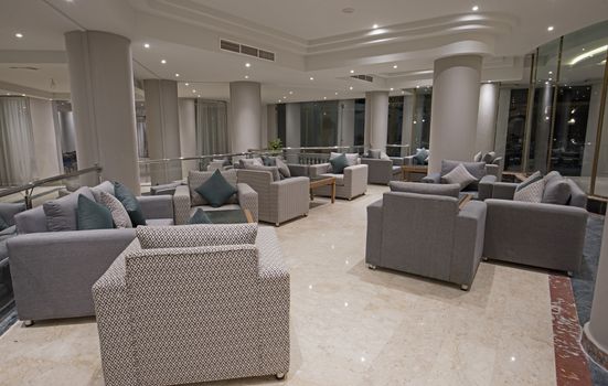 Interior design of large modern luxury hotel lobby seating area with furniture