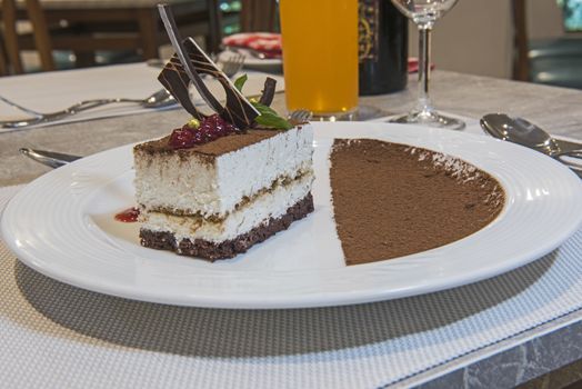 Tiramisu dessert food at luxury a la carte restaurant with cocoa