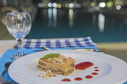 Fruit tart and coconut dessert food at luxury a la carte restaurant with strawberry sauce by swimming pool