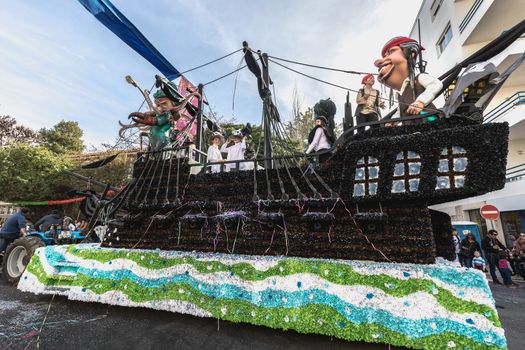 Loule, Portugal - February 25, 2020: Float parading in the street in front of the public in the parade of the traditional carnival of Loule city on a February day