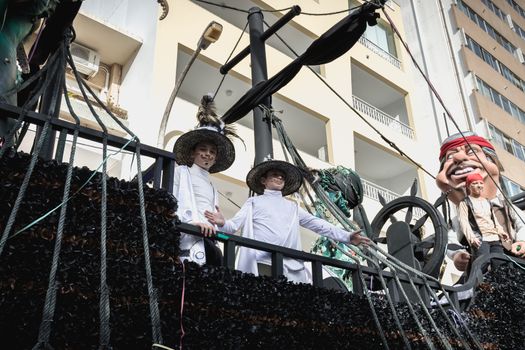 Loule, Portugal - February 25, 2020: Pirate ship float parading in the street in front of the public in the parade of the traditional carnival of Loule city on a February day