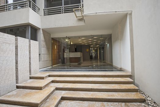 Entrance door and steps to a modern luxury apartment building