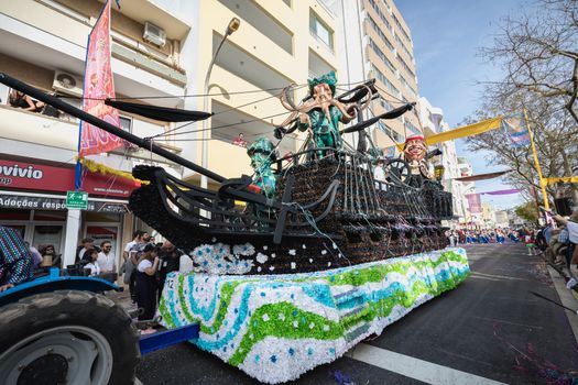 Loule, Portugal - February 25, 2020: Pirate ship float parading in the street in front of the public in the parade of the traditional carnival of Loule city on a February day