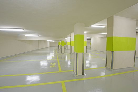 Interior of a new modern underground carpark beneath an apartment building with columns
