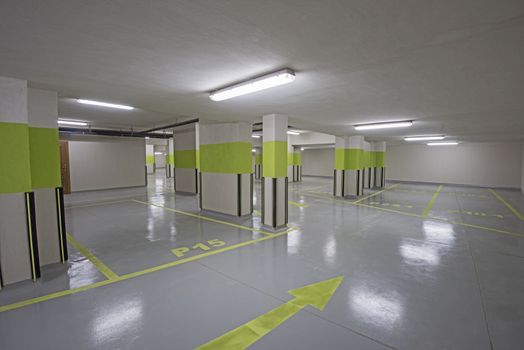 Interior of a new modern underground carpark beneath an apartment building with columns