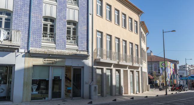 Ovar, Portugal - February 18, 2020: architectural detail of the typical houses of the city decorated for the carnival where people are walking on a winter day