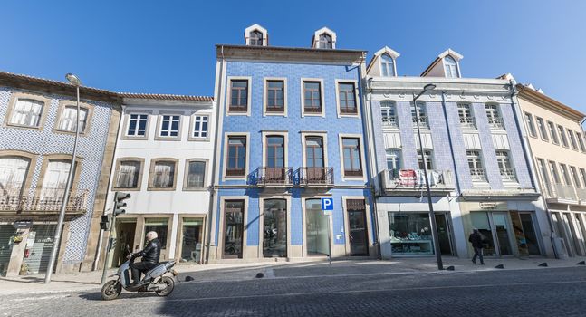 Ovar, Portugal - February 18, 2020: architectural detail of the typical houses of the city decorated for the carnival where people are walking on a winter day