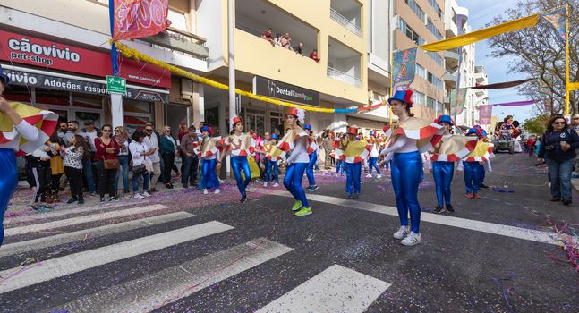 Loule, Portugal - February 25, 2020: dancers parading in the street in front of the public in the parade of the traditional carnival of Loule city on a February day