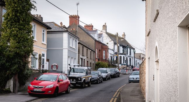 Howth, Ireland - February 15, 2019: Typical architecture of town center houses in a small fishing port near Dublin on a winter day