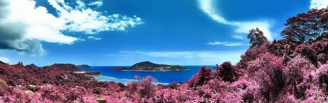 Beautiful purple and pink infrared panorama of a landscape on the Seychelles Islands.