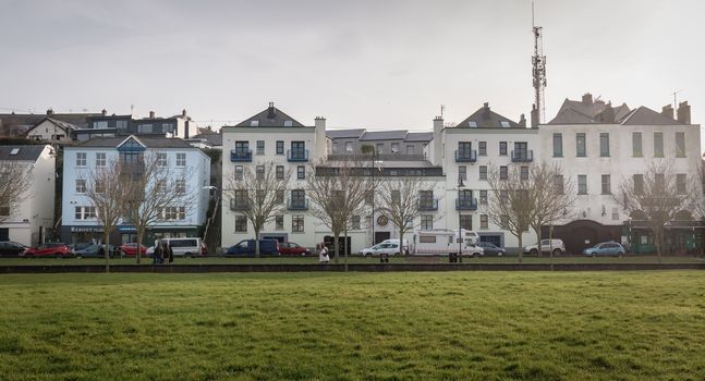 Howth, Ireland - February 15, 2019: Typical architecture of town center houses in a small fishing port near Dublin on a winter day