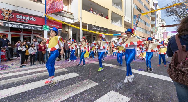 Loule, Portugal - February 25, 2020: dancers parading in the street in front of the public in the parade of the traditional carnival of Loule city on a February day