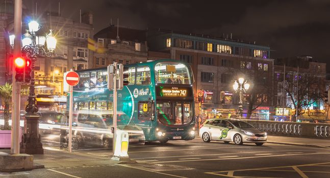 Dublin, Ireland - February 15, 2019: street atmosphere and architectural detail at night in the historic city center where people walk on a winter evening