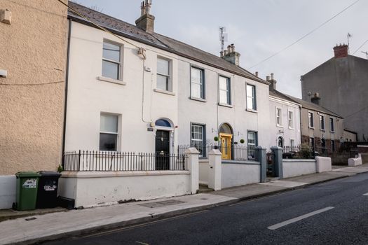 Howth, Ireland - February 15, 2019: Typical architecture of town center houses in a small fishing port near Dublin on a winter day