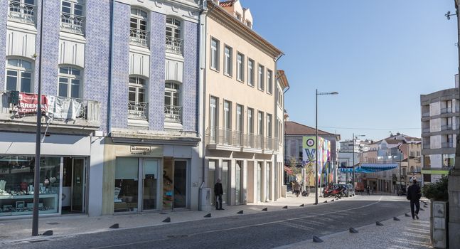 Ovar, Portugal - February 18, 2020: architectural detail of the typical houses of the city decorated for the carnival where people are walking on a winter day