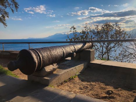 Old Ottoman time cannon with Mediterranean sea mountains and blue sky view