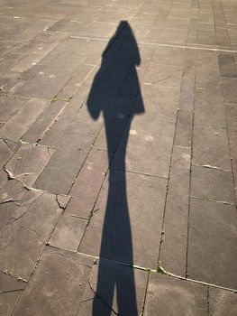 Long selfie shadow shade photo of a girl female on stone background 