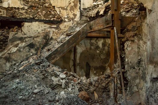 Ruins of burned ancient historical 2 floors house after fire disaster accident in old town of Antalya Kaleici Turkey. Stock image of heaps of ash and arson, collapsed roof and broken windows.