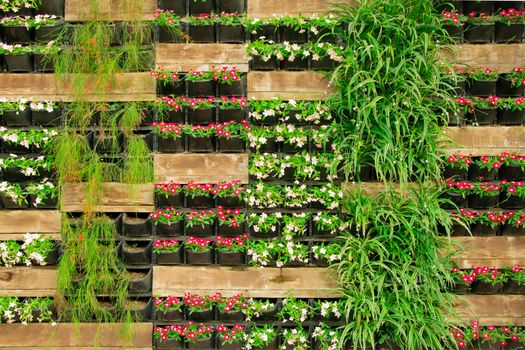Bright flower floral decorative wall fence, vertical flowerbed plant pot. Stock image.	