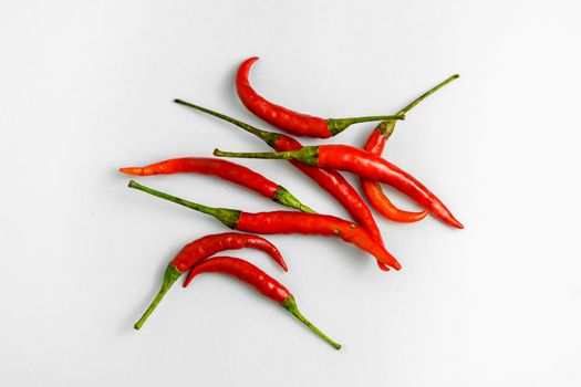 Close-up shot of red peppers on a white background. Fresh food ingredients concept.