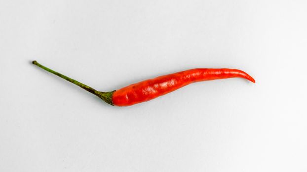 Close-up shot of red peppers on a white background. Fresh food ingredients concept.