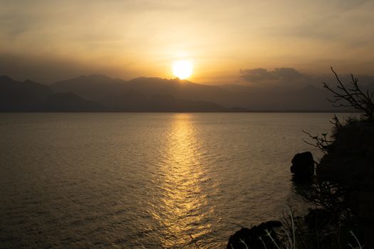 Majestic Tropical Orange Summer Sunset Sunrise Over Sea with Mountains Silhouettes