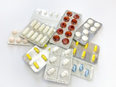 Many plenty a lot of tablets in blister pack, pills, capsules on a white background. Horizontal image